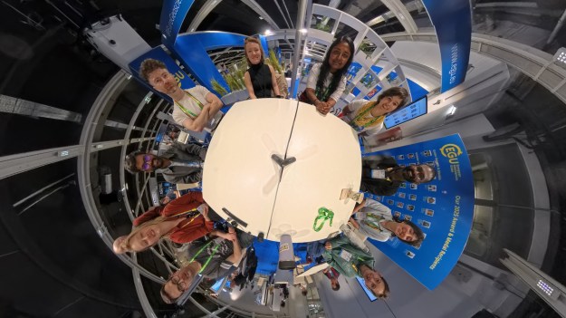 A group of people around a table from above.